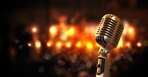 stage ligths come down upon a microphone on a branson missouri stage