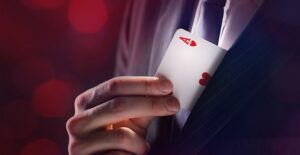 a branson magician slips a card into his front coat pocket