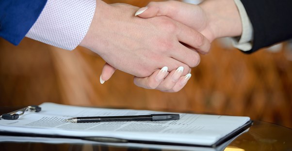 Women with an intense french manicure shaking hands