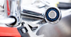A wrench laying next to a newly installed tankless water heater