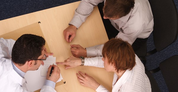 Coworkers work together to solve a problem