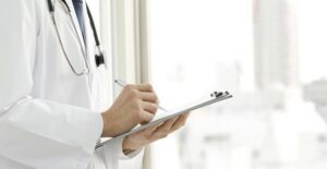 a doctor writing down four things that a pap smear does not detect