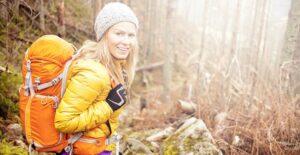 Woman smiling as she camps during the fall season