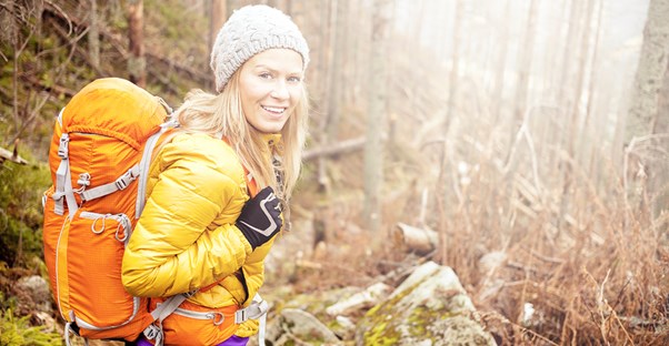 Woman smiling as she camps during the fall season