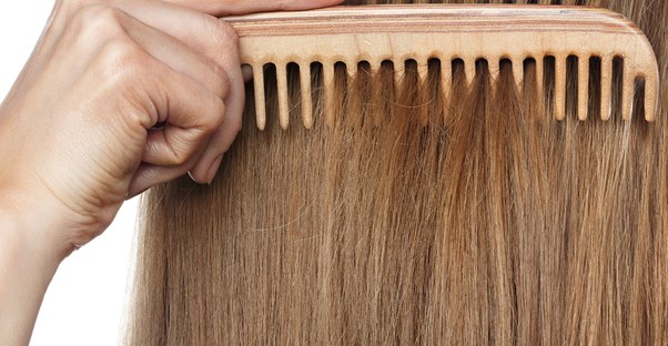 a woman applying dry shampoo
