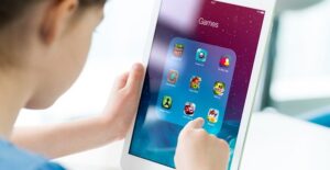 A child plays games on a tablet