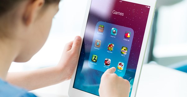 A child plays games on a tablet