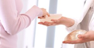 Woman testing breast implants as she asks about breastfeeding