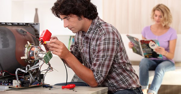 Man repairing a home appliance