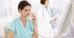 A medical billing and coding specialist answers a phone