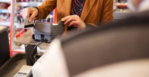 Woman paying with her credit card and earning cash back on her purchases