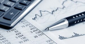 Calculator, pen, and graph of stock prices