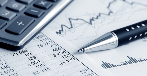 Calculator, pen, and graph of stock prices