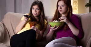 Two friends watching a scary halloween movie
