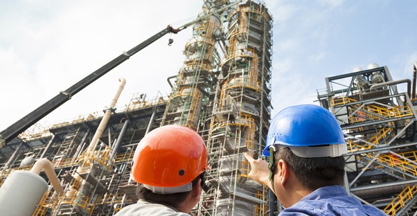 A chemical engineer points at something and the another chemical engineer looks