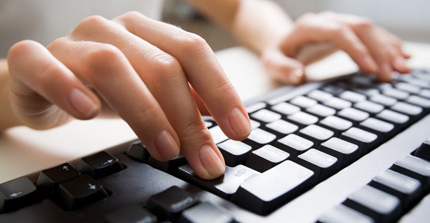 Fingers type on a keyboard