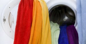 Clothes with melted crayon on them coming out of the washing machine