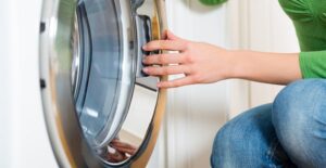 Woman cleaning a washing machine