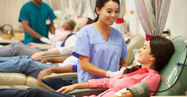 Nurse helping a patient while enjoying student loan forgiveness