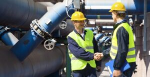 Chemical engineers shake hands