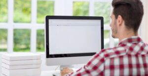 A man stares at his blank computer screen