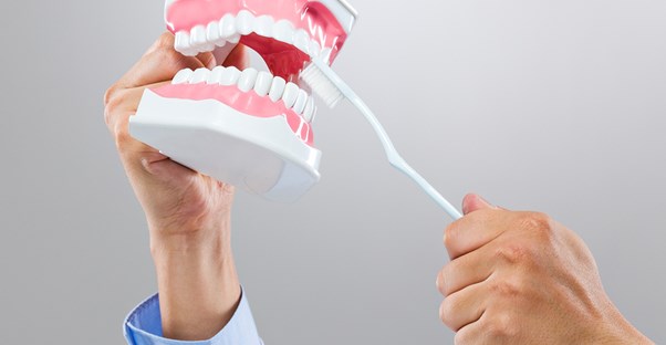 a man maintaining a pair of dentures