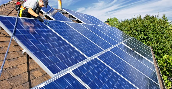 solar panels being installed on a roof