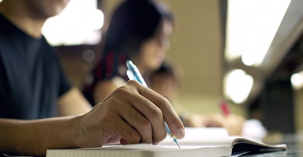 A student takes notes during class