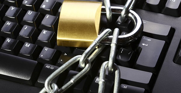 A keyboard with chains and a lock on it