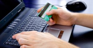 Someone using their secured credit card with a low deposit