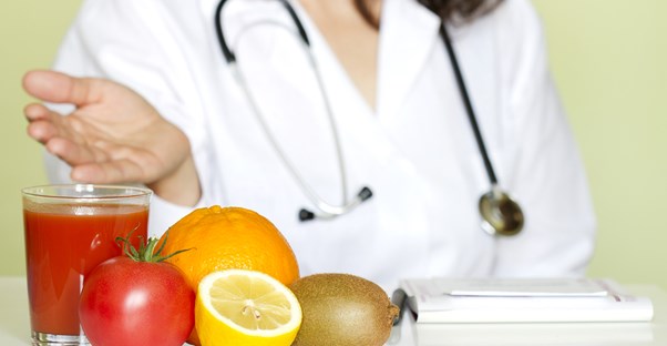 A nutritionist shows the camera her fruit juice