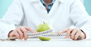 a nutritionist measuring an apple
