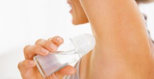 a woman using clinical strength deodorant