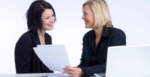 A woman reviewing her finances with a life coach