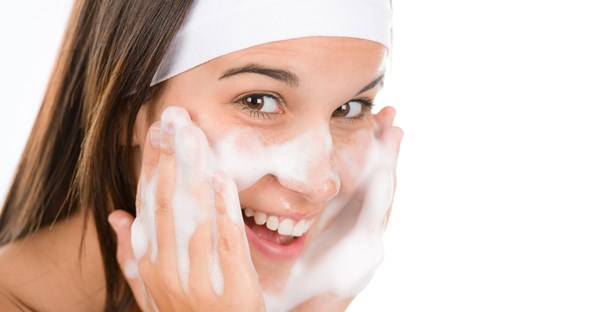 A young girl gets really excited about washing her face