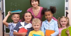 A teacher hugs her students