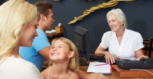 a smiling family checks into their barcelona hotel, for the last time