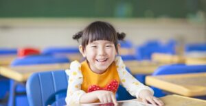 A little girl enjoys playing on her tablet