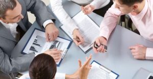 Project manager helping a group complete a task