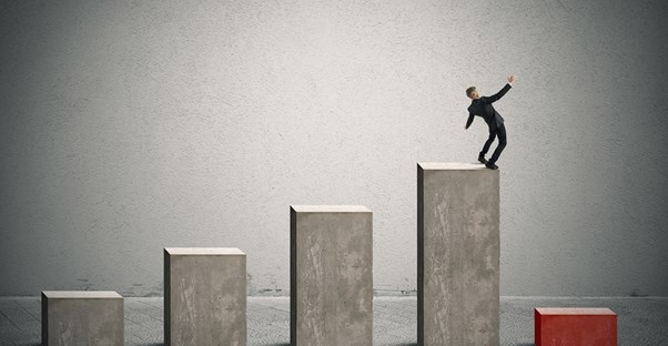 Man about to fall off of a graph because of poor risk management