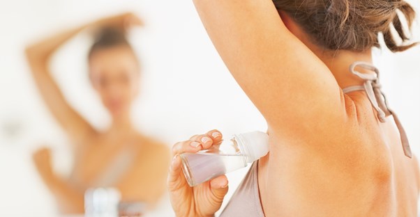 a woman who is using antiperspirant