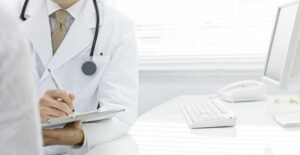 a doctor determining whether a patient needs a colonoscopy