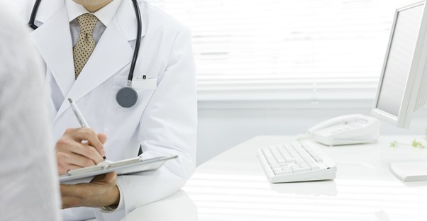 a doctor determining whether a patient needs a colonoscopy