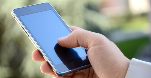 A man using one of the best cell phones on the market