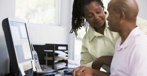 A man trying to be productive in his home office as his wife asks him a question