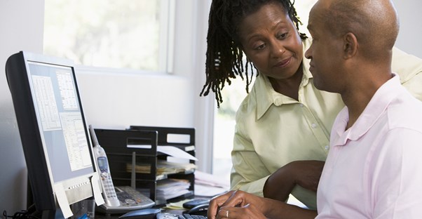 A man trying to be productive in his home office as his wife asks him a question