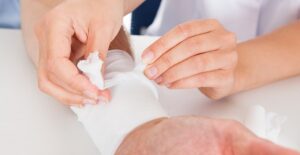 a woman treating an emergency that requires a first aid kit
