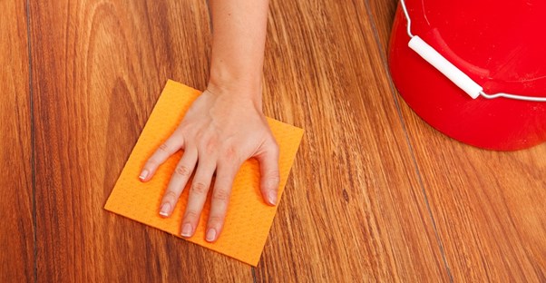 Woman cleaning her wood floors the right way