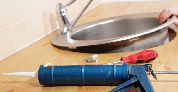 A sink being installed in a kitchen countertop