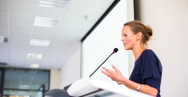 A life coach gives a motivational speech at a conference